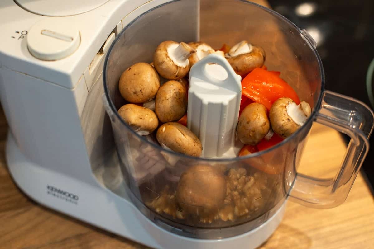 Mushrooms, peppers, red onion and walnuts in a food processor.