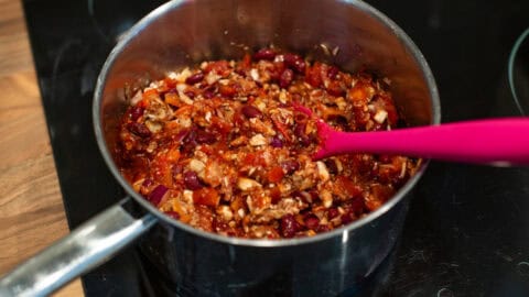 Uncooked vegetarian bean chilli in a saucepan.