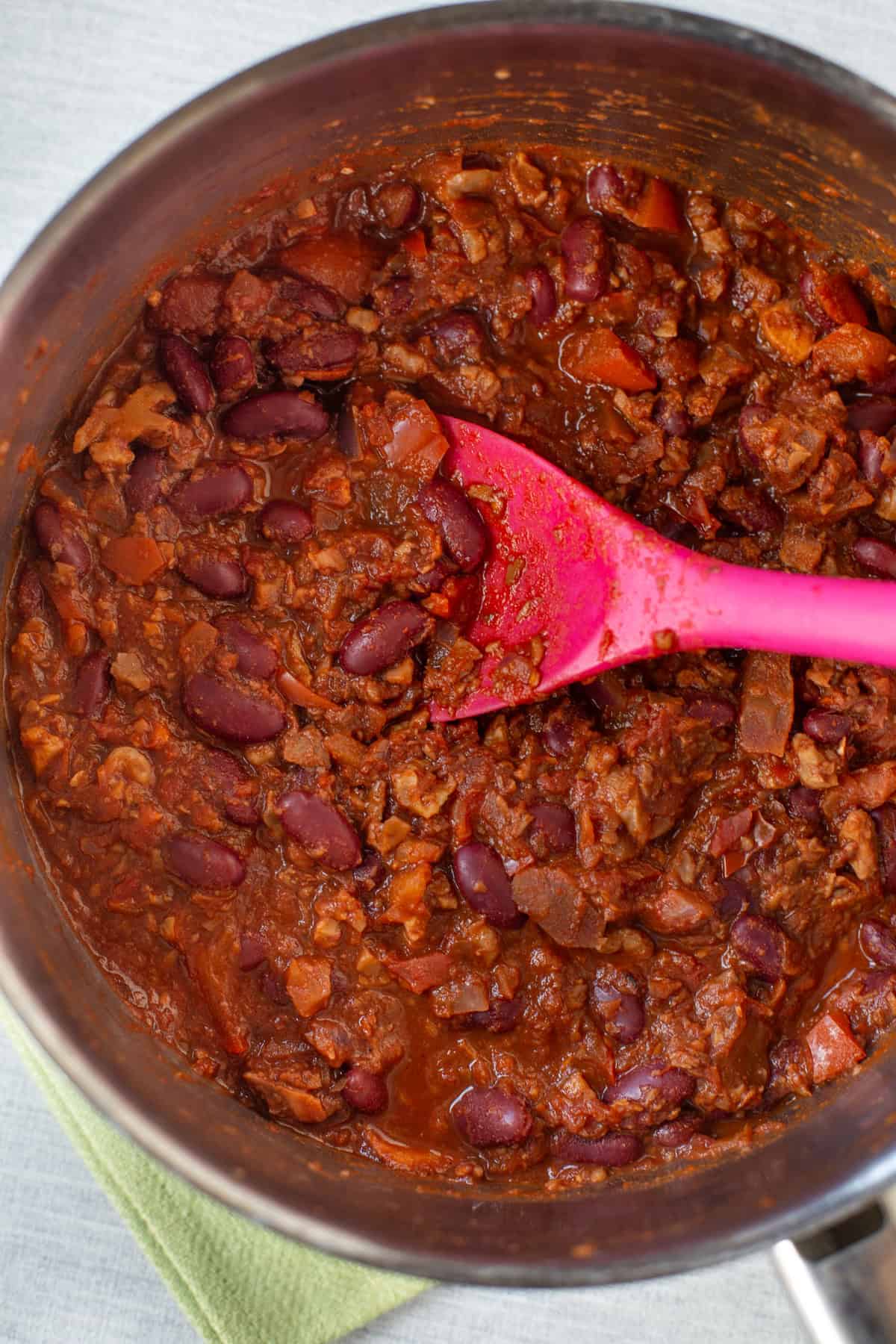 Overhead shot of vegan kidney bean chilli in a saucepan.