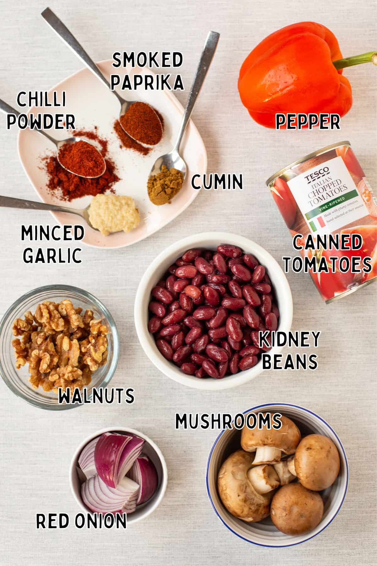 Ingredients for easy vegan kidney bean chilli laid out with text overlay.