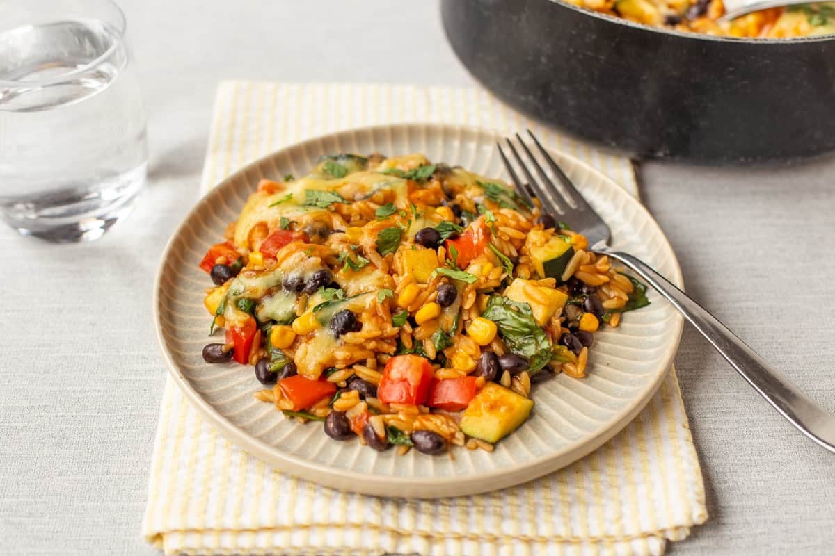 A portion of vegetarian enchilada orzo topped with cilantro.