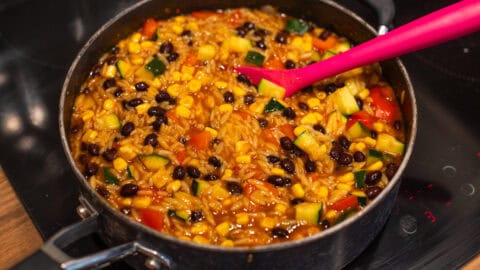 Orzo, black beans and veggies in a large frying pan.