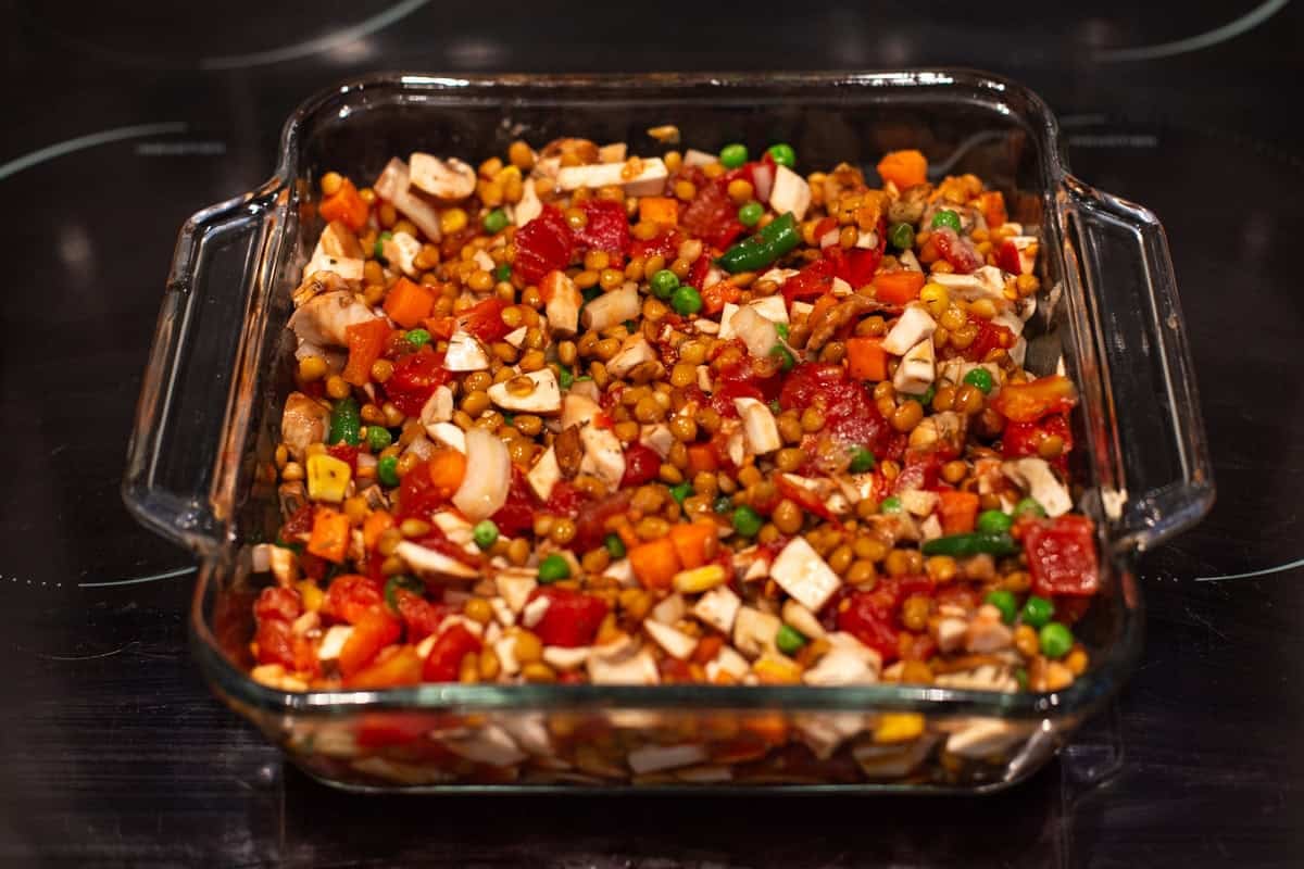 Lentil and vegetable mixture in a baking dish.