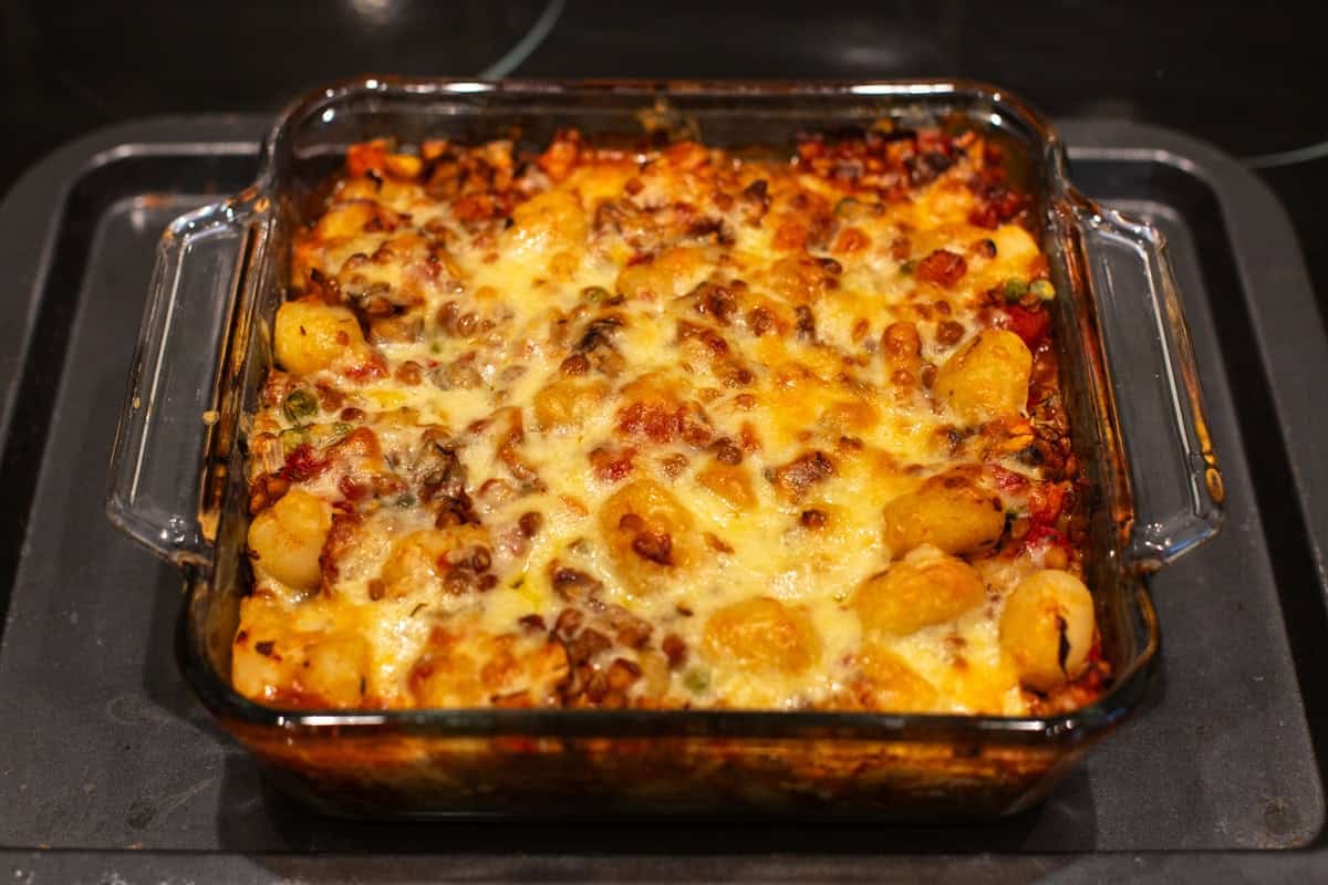 Cheesy baked gnocchi in a baking dish.