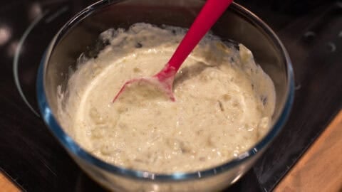 Tomatillo and sour cream sauce in a mixing bowl.