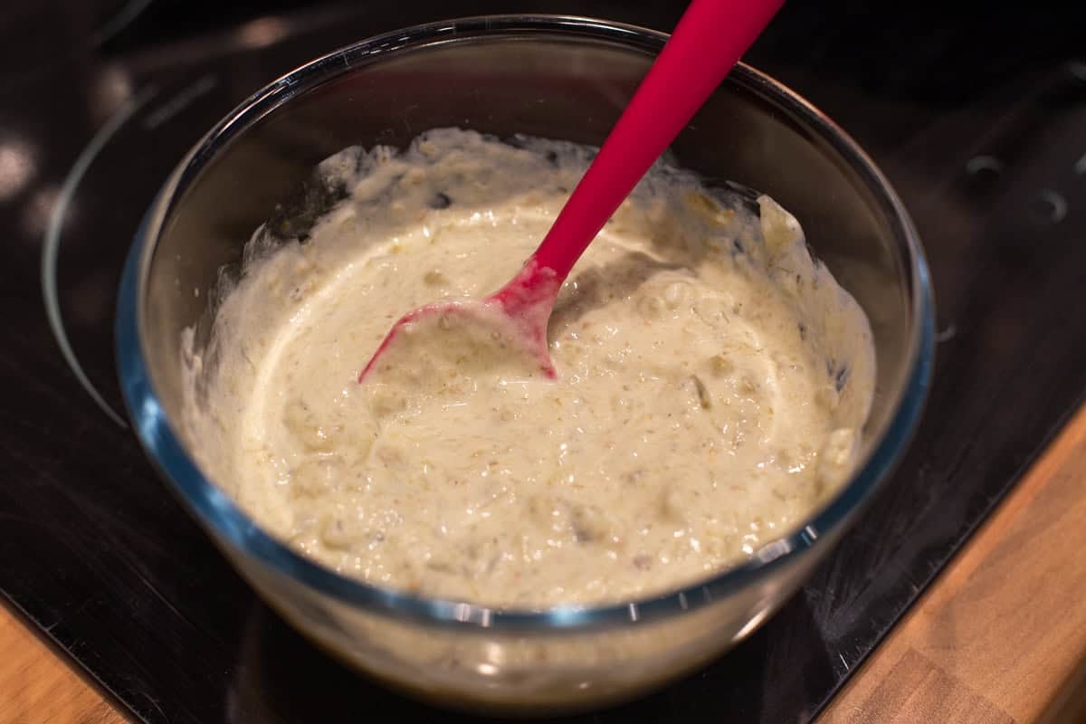 Tomatillo and sour cream sauce in a mixing bowl.