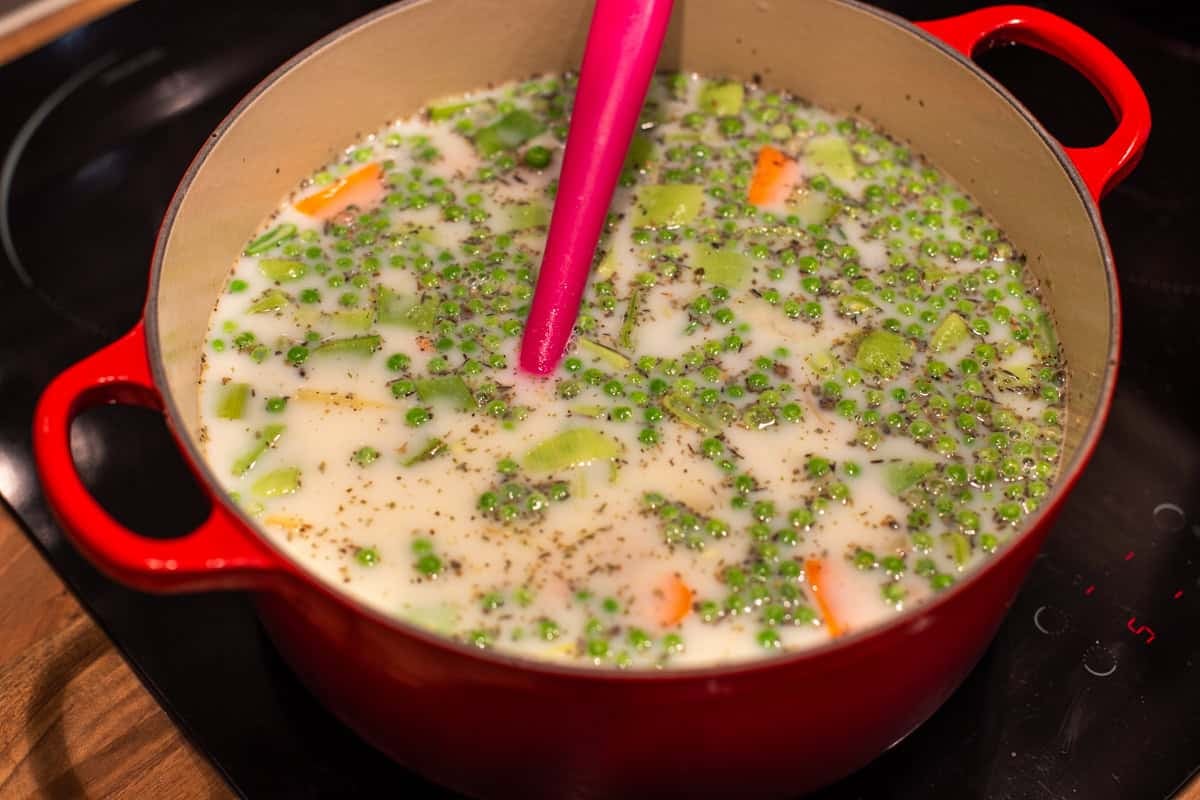 Vegetables and a creamy sauce in a large pot.