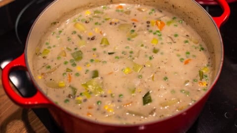 Creamy vegetable stew in a large pot on the stovetop.