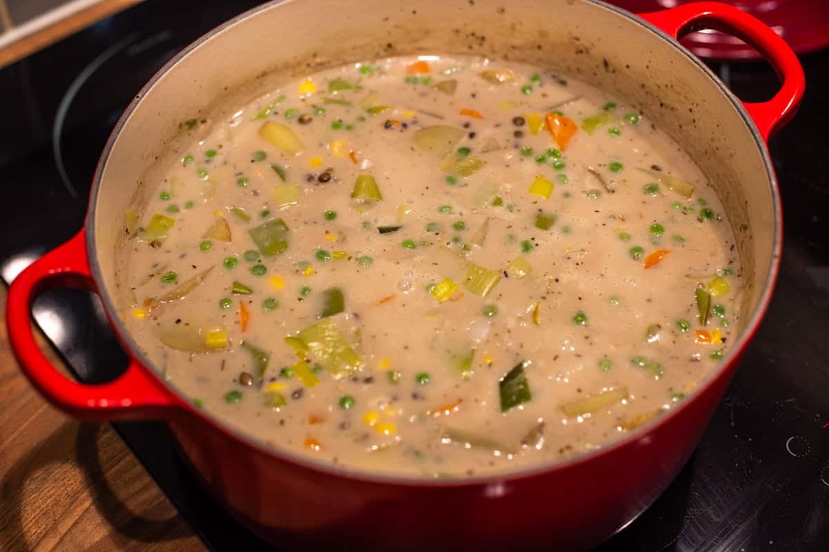 Creamy vegetable stew in a large pot on the stovetop.
