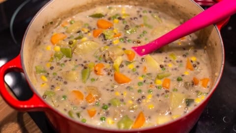Creamy vegetable stew cooking in a large pot.