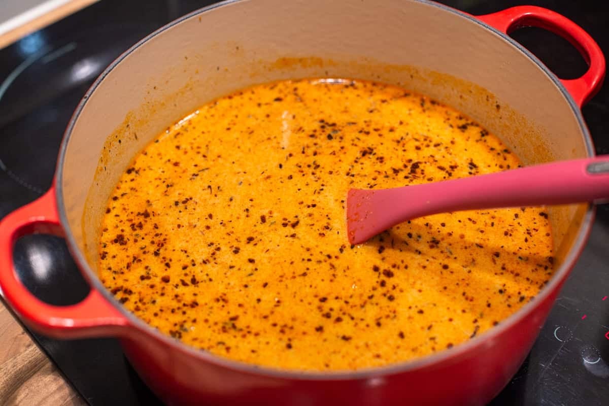 Ingredients for pumpkin mac and cheese in a large pot.