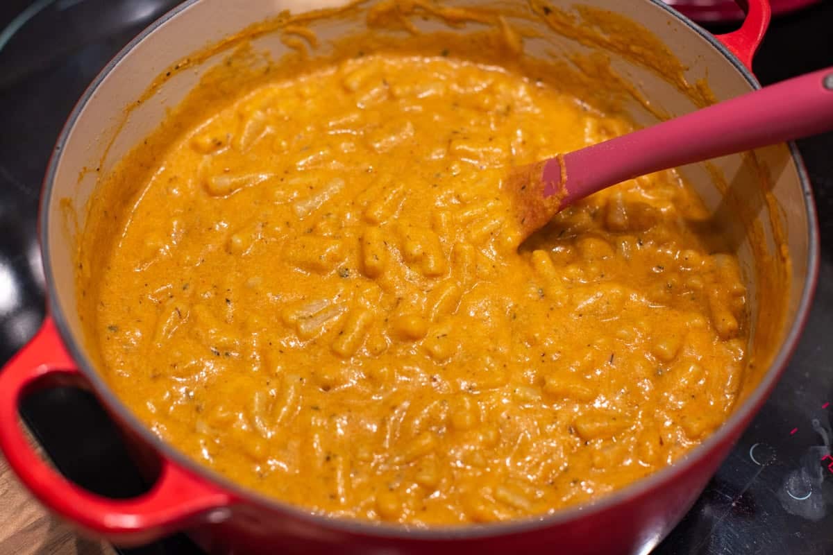 Creamy pumpkin mac and cheese in a large pot.