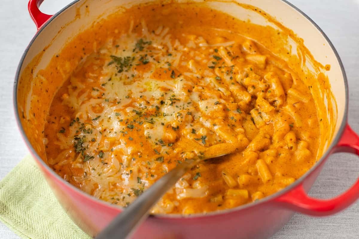 Cheesy pumpkin mac and cheese in a large pot.