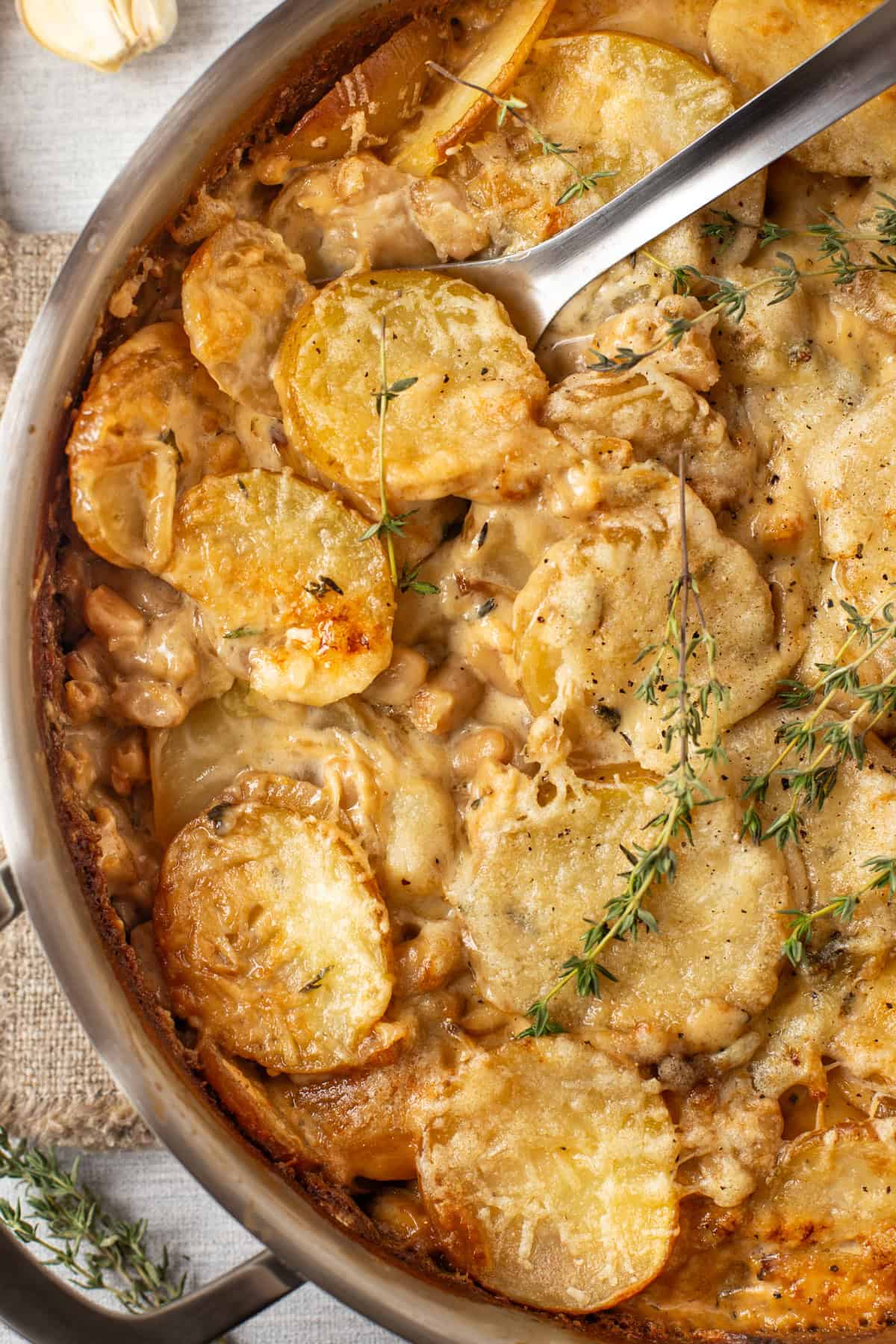 Overhead shot of French onion potato bake in a metal pan.